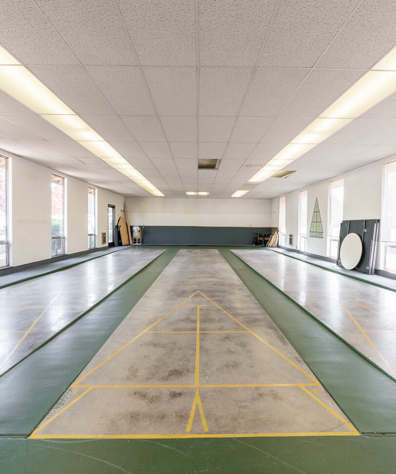Indoor shuffleboard courts hall inside a clubhouse in Lakewood Vista community.